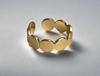 Minimalist adjustable circle ring in gold with sleek geometric design.