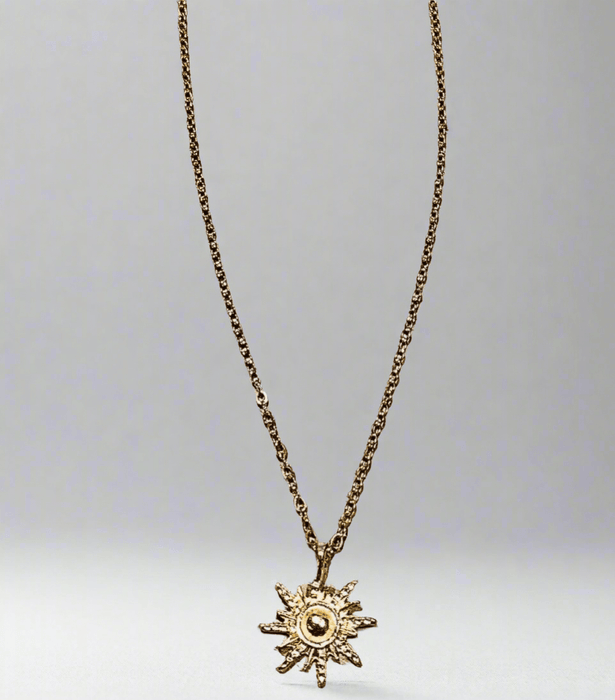 Extended chain gold sunburst pendant with 18K gold plating and recyclable components.