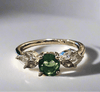 Emerald gemstone ring with gold plating and conflict-free zirconia stone, eco-friendly design.