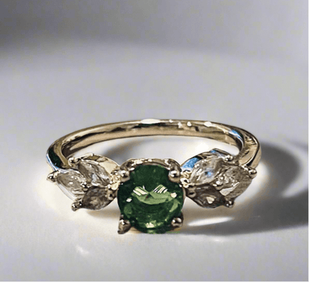 Emerald gemstone ring with gold plating and conflict-free zirconia stone, eco-friendly design.