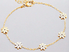 Golden Daisy Bracelet with floral motifs on a delicate gold chain, crafted from recycled gold for sustainable elegance.