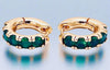 Emerald stone huggie hoops with 24K gold-filled brass and cubic zirconia accents.
