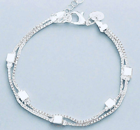 Sterling silver charm bracelet made from recycled materials with elegant design.