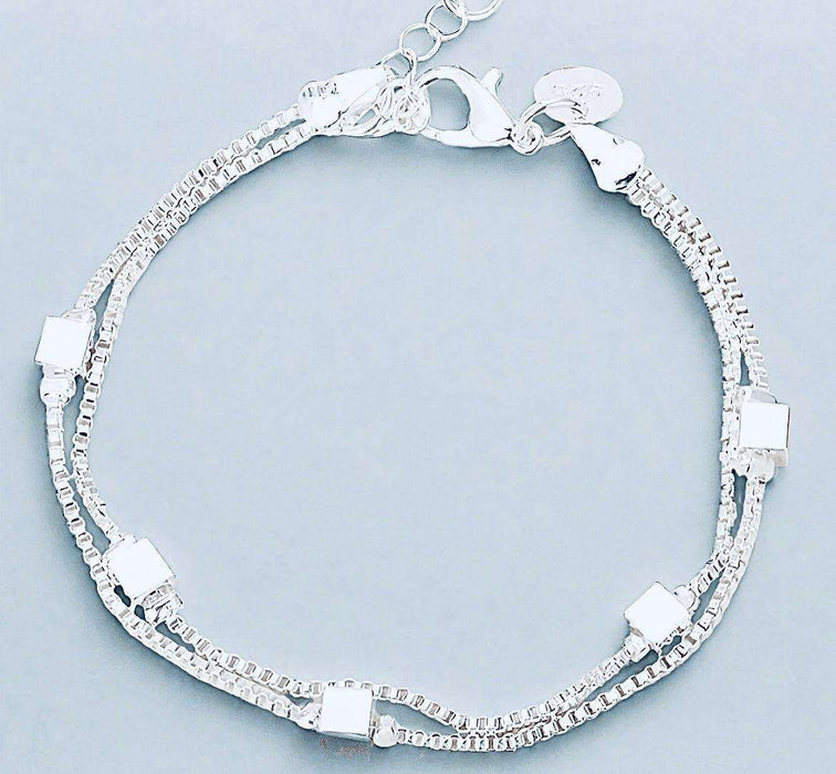 Sterling silver charm bracelet made from recycled materials with elegant design.