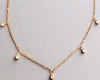 Minimalist gold beaded choker with sparkling rhinestones, eco-friendly 14K gold plating, adjustable chain.