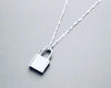 Sterling silver lock necklace with a sustainable and elegant design on a twisted chain.