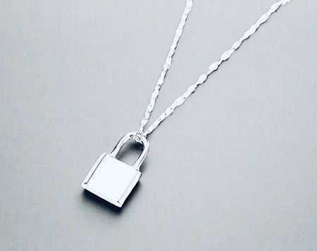 Sterling silver lock necklace with a sustainable and elegant design on a twisted chain.